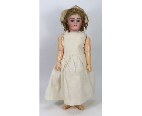 A Simon & Halbig 1079 bisque head doll, German circa 1915, with weighted blue glass eyes, open mouth, upper teeth and origina