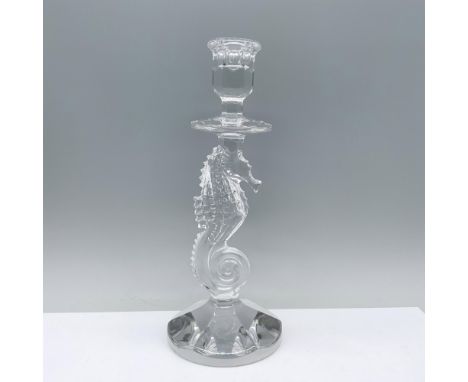 A captivating clear candlestick featuring a sturdy round base, adorned with a finely detailed seahorse centerpiece, culminati