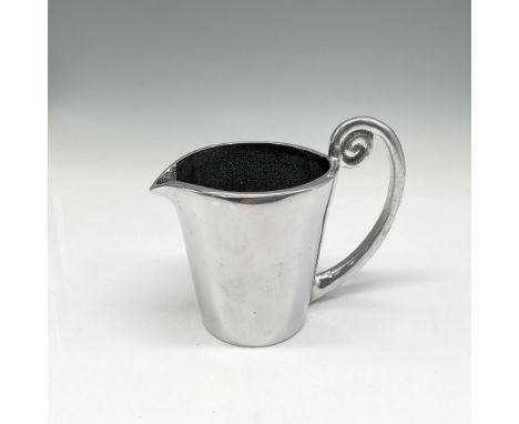 Another creative kitchen item a Milk jug with a twist. Carrol Boyes mark. Issued: 21st centuryDimensions: 5.5"L x 3.25"W x 4.