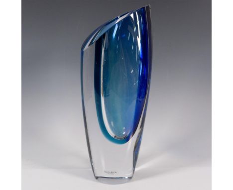 Clear with an angled surface, and decorated with a distinctive curved light blue and dark blue interior. Kosta Boda stickered