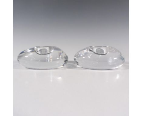 Duo of thick clear crystal resembles to an oval shape. Orrefors etched backstamp. Artist: Lena BergstromDimensions: 4''L x 4.