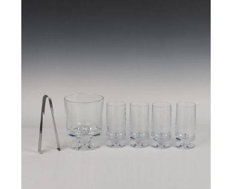 An ice bucket with hooked tongs and 4 sleek glasses, each with slender grooves for added style. Nambe backstamp. Dimensions o