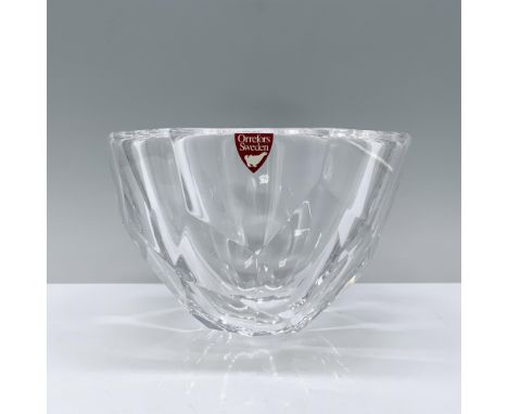 Clear with a round rim, adorned with smooth hexagonal and square cuts. Orrefors manufacturing sticker. Orrefors backstamp. Di