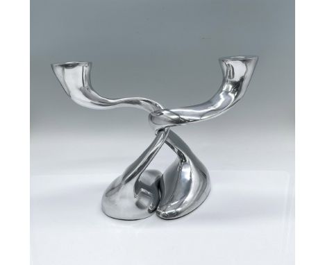 A set of 2 windy column silver-chrome colored candleholders. The set can be interlaced together or separate. Together: 10.75"