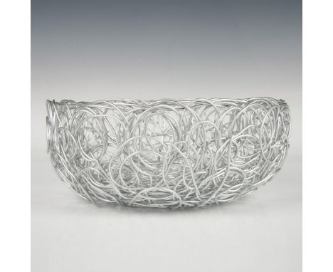 A bowl crafted from intersecting and looping silver-toned wires. Marked Alessi. Marked Fratelli Campana. This item has its or