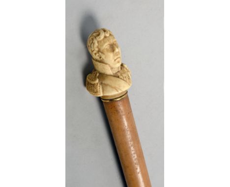 A 19c stripped cane walking stick with a carved bone Duke of Wellington handle, 37in l.