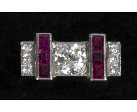 An Art Deco style white gold ring set with a central solitaire diamond, approx. 1ct, ruby borders and diamond panels.