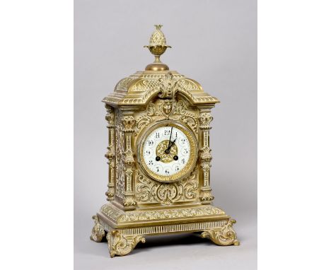 A late 19c French mantel clock in cast brass case decorated in scrollwork and foliage and having ornate bracket feet to the p