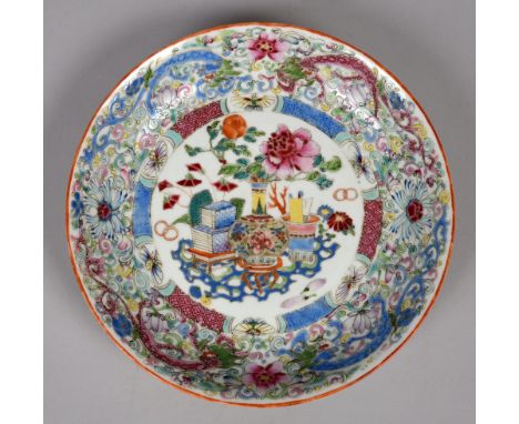 A 19c Chinese famille rose circular dish with central circular panel decorated with a famille rose vase within an outer borde