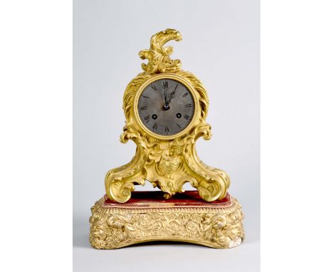 A mid 19c French mantel clock by Jules Denand of Paris in ormolu rococo style waisted case decorated with foliage. The tarnis