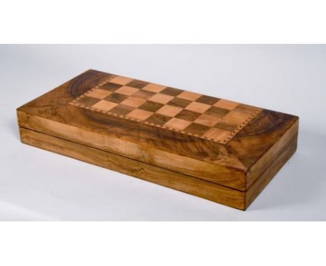 A late 19c/early 20c figured walnut backgammon board with chequered surface within crossbanding, folding and opening to revea