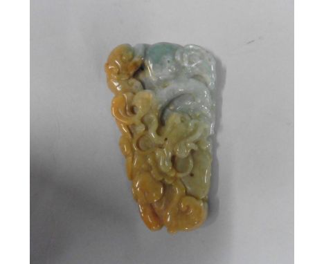 A Celedon and jade pendant carved as a dragon in the waves, 3in l, 1.5in w.
