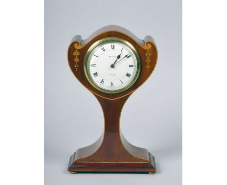 An early 20c French mantel clock in Art Nouveau 'Tulip' shaped balloon case in mahogany with boxwood edge stringing and inlai