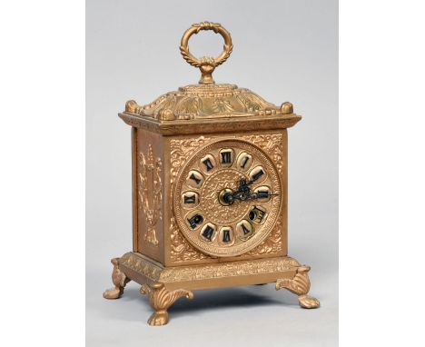 A mid 20c gilt brass mantel clock with German movement. The case has paw feet supporting a plinth base and it and the clock b