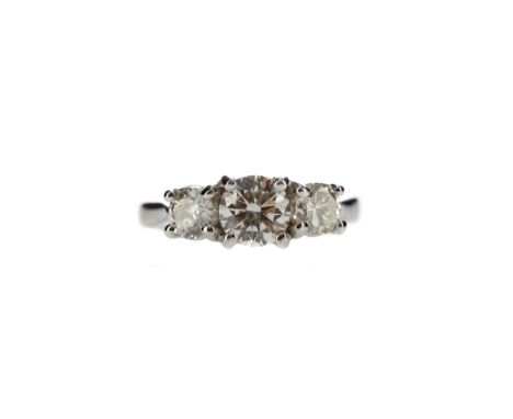 DIAMOND THREE STONE RING, set with a central round brilliant cut diamond of approximately 0.82 carats, flanked by two smaller