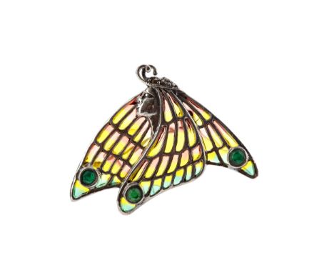 PLIQUE A JOUR BROOCH, depicting a female in profile facing left, with bezel set emeralds and yellow, orange and green enamel,