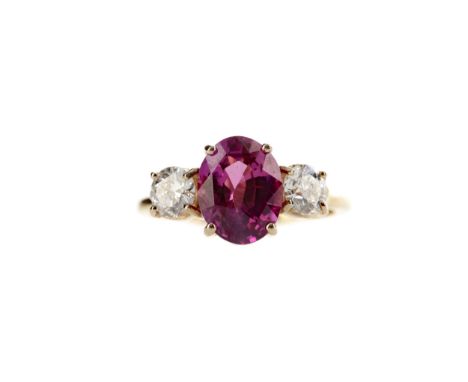 PINK SAPPHIRE AND DIAMOND RING, set with an oval pink sapphire of approximately 3.09 carats flanked by two round brilliant cu