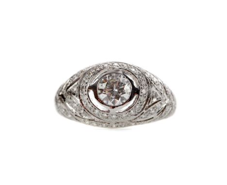DIAMOND DRESS RING, set with a central bezel set round brilliant cut diamond of approximately 0.60 carats with small round br