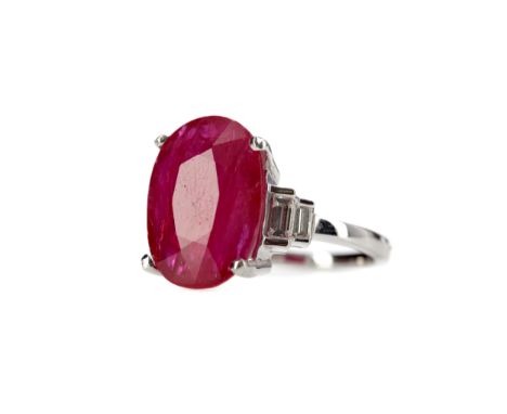 RUBY AND DIAMOND RING, set with an oval ruby of approximately 8.22 carats flanked by two baguette cut diamonds on either shou