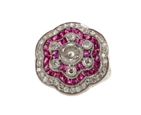 RUBY, SPINEL AND DIAMOND RING, the central diamond of approximately 0.80 carats surrounded by calibre cut rubies and spinels,