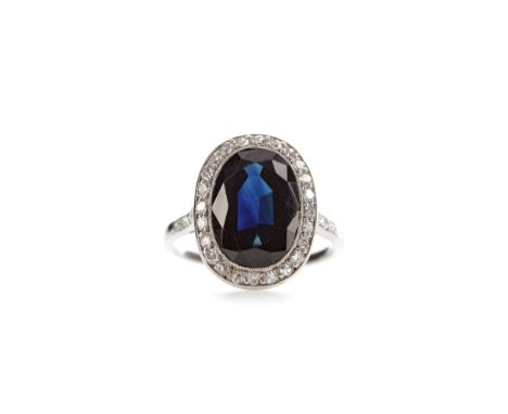 SAPPHIRE AND DIAMOND RING, set with an oval sapphire of approximately 4.75 carats, within a halo of round brilliant cut diamo