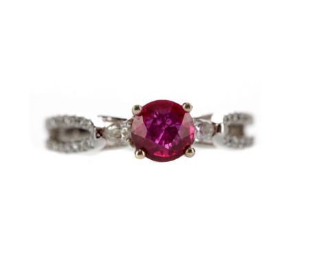 RUBY AND DIAMOND RING, set with a round ruby of approximately 0.86 carats flanked by two marquise shaped diamonds, with round