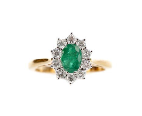 EMERALD AND DIAMOND CLUSTER RING, set with an oval emerald of approximately 0.80 carats within a halo of round brilliant cut 