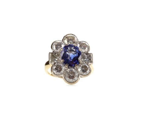 SAPPHIRE AND DIAMOND RING, set with an oval sapphire of approximately 2.00 carats flanked by two princess cut diamonds and a 