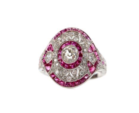 RUBY, SPINEL AND DIAMOND RING, set with a central old mine cut diamond of approximately 0.63 carats surrounded by round brill