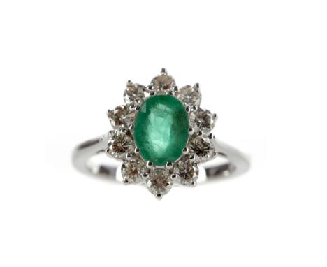 EMERALD AND DIAMOND RING, set with an oval emerald of approximately 1.20 carats, within a round brilliant cut diamond halo to