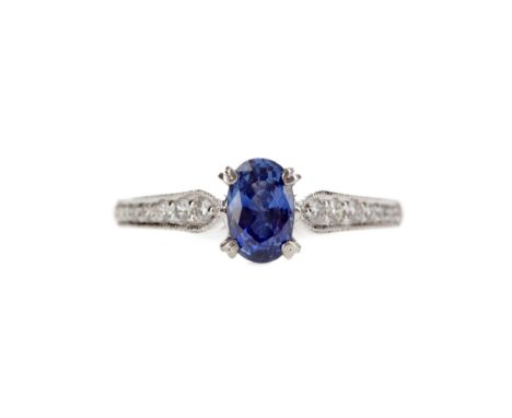 SAPPHIRE AND DIAMOND RING, set with an oval sapphire of approximately 0.96 carats on diamond set shoulders, the diamonds tota