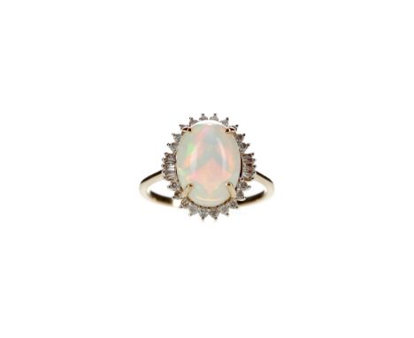 OPAL AND DIAMOND RING, set with a cabochon opal of approximately 5.00 carats surrounded by round brilliant and baguette cut d