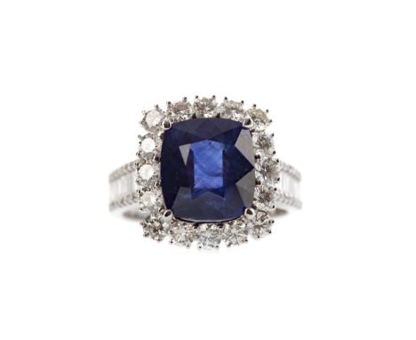 SAPPHIRE AND DIAMOND RING, set with a cushion cut sapphire of approximately 5.51 carats within a halo of round brilliant cut 