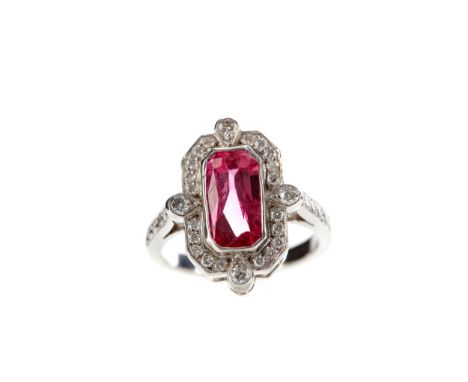 ART DECO STYLE RUBY AND DIAMOND RING, set with an elongated ruby of approximately 2.36 carats, bordered by round brilliant cu
