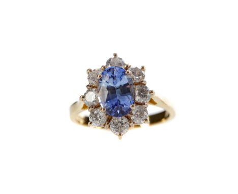 SAPPHIRE AND DIAMOND RING, set with an oval sapphire of approximately 2.35 carats within a halo of round brilliant cut diamon