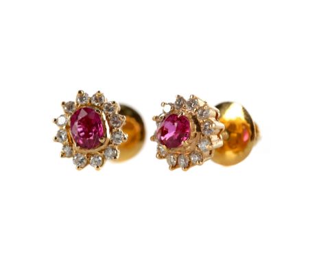 PAIR OF RUBY AND DIAMOND CLUSTER EARRINGS, each set with an oval ruby within a halo of round brilliant cut diamonds, the rubi