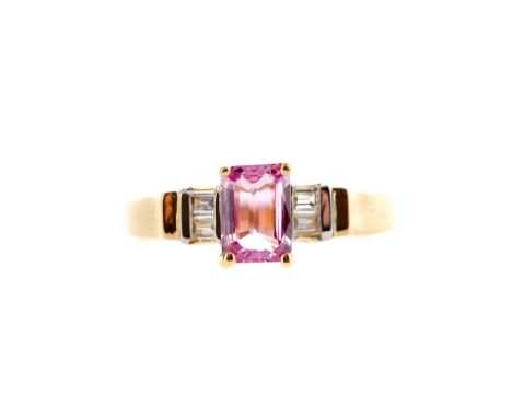 PINK SAPPHIRE AND DIAMOND RING, set with an emerald cut sapphire of approximately 1.00 carat flanked by two baguette cut diam