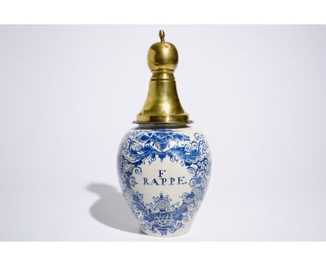 A Dutch Delft blue and white tobacco jar with brass cover, 18th C. H.: 46 cm (incl. cover)  Provenance: With a label on the b
