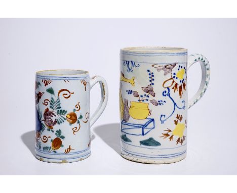 Two polychrome Dutch Delft mugs with birds, vases and flowers, 18th C. H.: 20 cm (the tallest)  Provenance: Both with a label