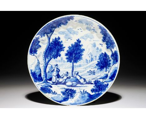 A fine Dutch Delft blue and white plate with travellers in a landscape, early 18th C. Dia.: 22 cm  Marked on the base "R" for