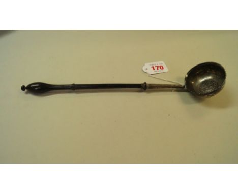 An antique metal toddy ladle, inset Spanish silver coin 1722, with turned wooden handle, 30cm.