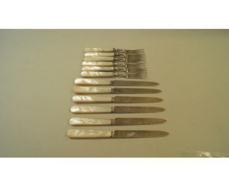 A set of six pairs of silver tea knives and forks having mother of pearl handles, by C W Fletcher & Son Ltd, Sheffield 1933. 