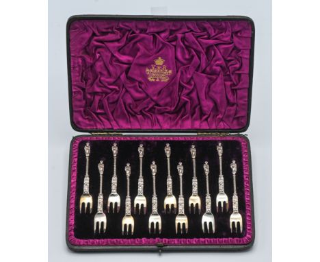 An Elkington &amp; Co. 12 piece silver apostle cake fork set. Victorian, London. Makers mark FE, in fitted original case. App
