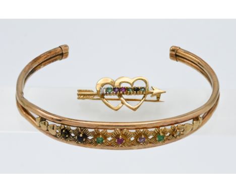 A 9 carat and coloured stone set 'slave' bangle together with a 9 carat double heart and stone set matching brooch. Approx 6.