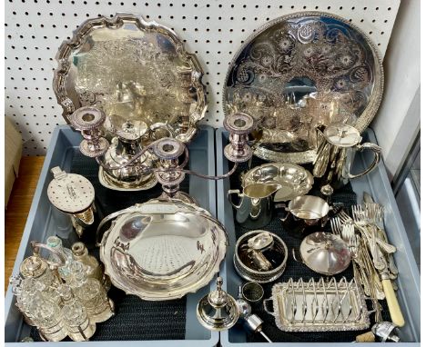 A quantity of silver plated wares including serving trays, candelabra, cake stands, seven bottle cruet set, flatware, coaster