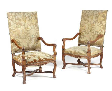 A PAIR OF CONTINENTAL WALNUT HIGHBACK ARMCHAIRSIN LOUIS XIV STYLE, FIRST HALF 20TH CENTURYeach with scroll arms, the apron ca