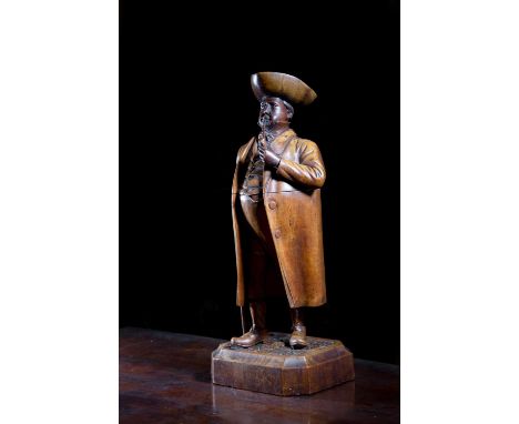 A TREEN FRUITWOOD BURGHER TOBACCO JARPOSSIBLY BLACK FOREST, 19TH CENTURYmodelled standing wearing a tricorn hat and an overco