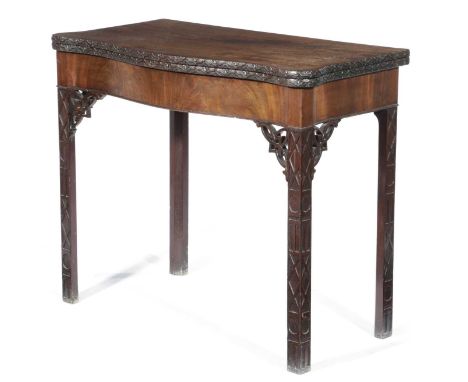 A MAHOGANY SERPENTINE CARD TABLEIN CHINESE CHIPPENDALE STYLE, 19TH CENTURYthe hinged top with a floret carved edge revealing 