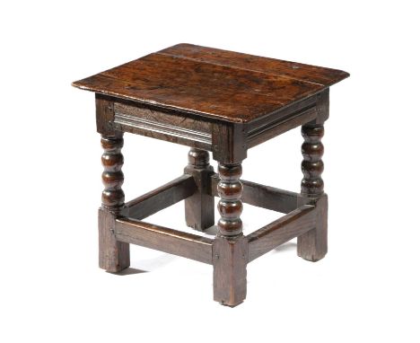 A CHARLES II OAK LOW STOOLC.1670-80the moulded frieze above bobbin turned supports40cm high, 43.2cm wide, 38.5cm deepLiteratu