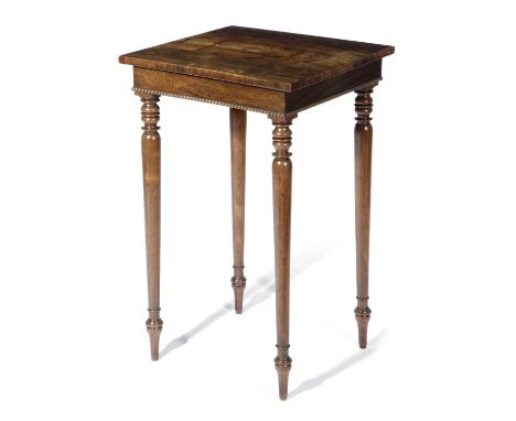 λ A WILLIAM IV ROSEWOOD LAMP TABLEC.1830with a concave front and nulled mouldings, on turned tapering legs74cm high, 45.6cm w
